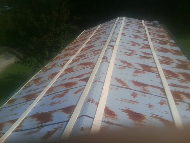 Rusted metal roof panels with new wood purlins before replacement — Storm Damage Roof Repair in Gladstone by Roofing Brothers